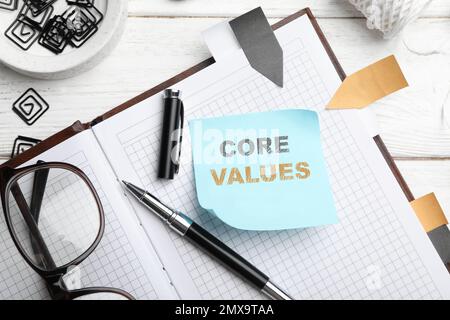 Core values concept. Flat lay composition with stationery on white wooden table Stock Photo