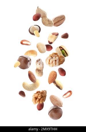 Different nuts falling on white background Stock Photo