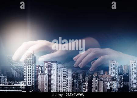 Double exposure of female programmer using laptop and cityscape, closeup Stock Photo