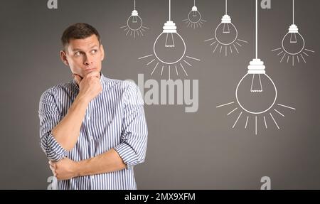 Lightbulbs illustration and thoughtful man in casual outfit on grey background. Business idea Stock Photo
