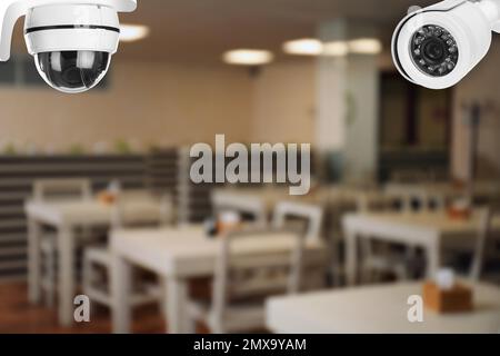 Modern CCTV security cameras in school canteen. Guard equipment Stock Photo