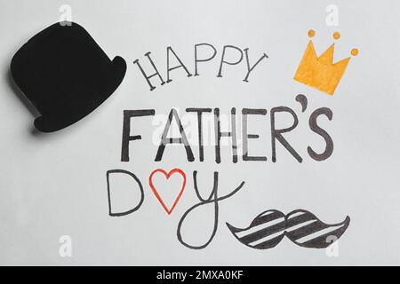 Paper hat on greeting card with phrase HAPPY FATHER'S DAY, top view Stock Photo