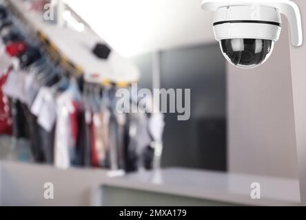 Modern CCTV security camera at dry-cleaner's. Guard equipment Stock Photo