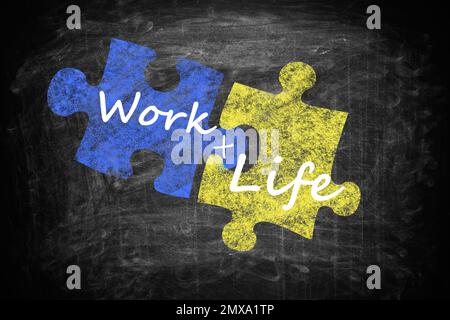 Work-life balance concept. Drawing of connected puzzle pieces on chalkboard Stock Photo