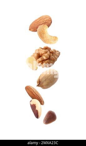 Different nuts falling on white background Stock Photo