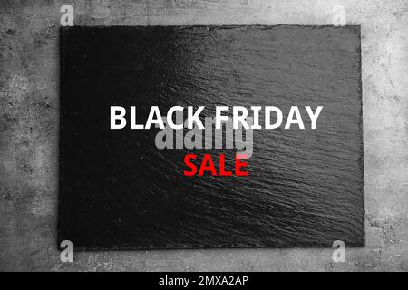 Textured slate board with text BLACK FRIDAY SALE on dark background, top view Stock Photo