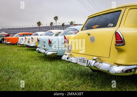 Daytona Beach, FL - November 11, 2022: Low perspective rear corner view of a group of parked 1955 Chevrolet Nomads, BelAirs, and 210 models at a local Stock Photo