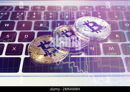 Golden and silver bitcoins on computer keyboard Stock Photo