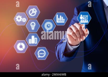 Core values concept. Businessman pointing at icon on virtual screen Stock Photo