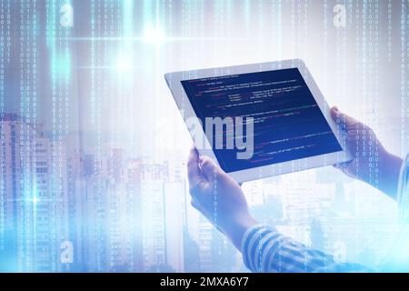 Multiple exposure of female programmer with tablet, digital binary code and cityscape, closeup Stock Photo