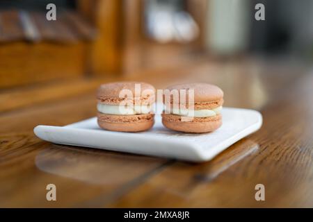 various delicious macaron cookies on a square plate stand Stock Photo