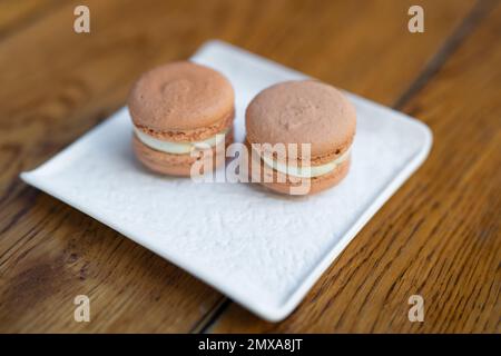 various delicious macaron cookies on a square plate stand Stock Photo