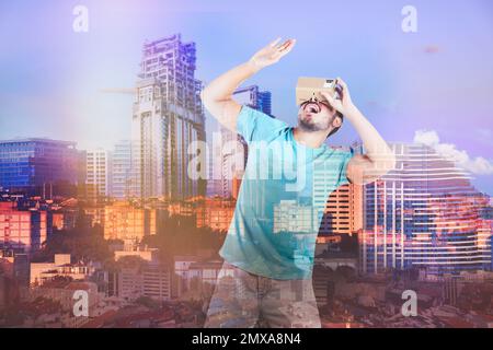 Double exposure of man using virtual reality headset and cityscape. Modern technology Stock Photo