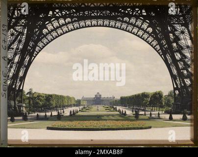 Paris (7th arr.), France Les Jardins du Champ-de-Mars and the Military School seen through the Arches of the Eiffel Tower , Stock Photo