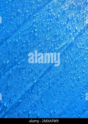 background of small water drops on blue synthetic material Stock Photo