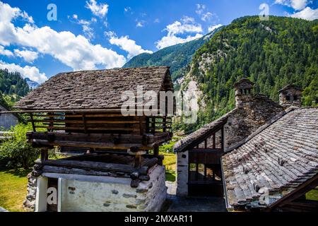Characteristic old buildings in stone and wood in the hamlet of Mogno, village of Fusio, Maggia Valley, Ticino, Switzerland, Fusio, Ticino Stock Photo