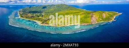 Aerial panoramic view of La Digue island, Seychelles, with Anse Source D'Argent beach in center, Anse Marron beach to the right, and the town La Passe Stock Photo