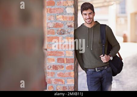 Education is a gift that no one can take away. Cropped portrait of a handsome young man standing outside while on campus. Stock Photo