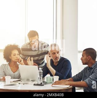 Discussing design. a group of coworkers having a meeting in an office. Stock Photo