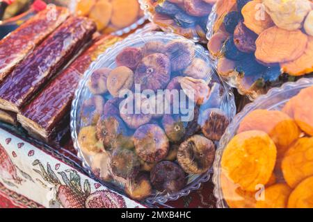 View of traditional armenian local candy sweets delights with churchkhela, sweet sausage, sudzhuk, dried fruits, walnuts and others for sale in local Stock Photo