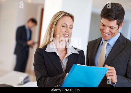 Effective collaboration in business. two business professionals discussing a document. Stock Photo