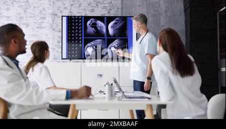 Physician Doctors Looking At Shoulder MRT Scan Stock Photo