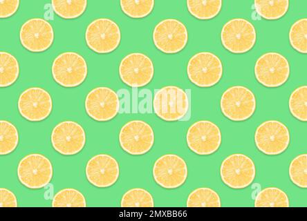 Pattern of lemon slices on light green background Stock Photo