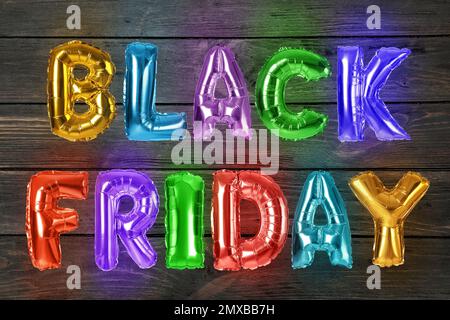 Phrase BLACK FRIDAY made of foil balloon letters on wooden background Stock Photo