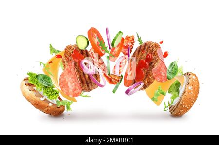 Delicious burger with different flying ingredients on white background Stock Photo