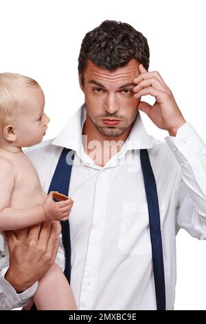 Theres a lot going on in his life. A businessman holding his son after a long day at work. Stock Photo