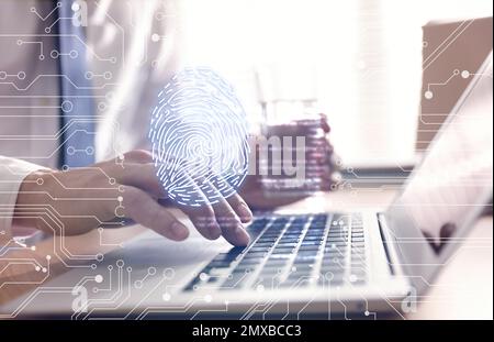 Fingerprint identification. Man working with laptop at table, closeup Stock Photo