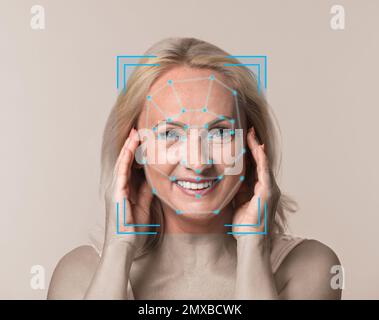 Facial recognition system. Mature woman with scanner frame and digital biometric grid on light background Stock Photo