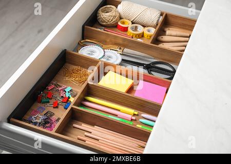 Different stationery in open desk drawer indoors Stock Photo