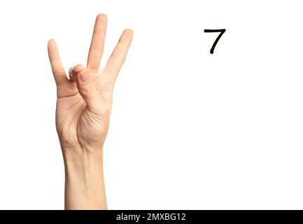 Woman showing number seven on white background, closeup. Sign language Stock Photo