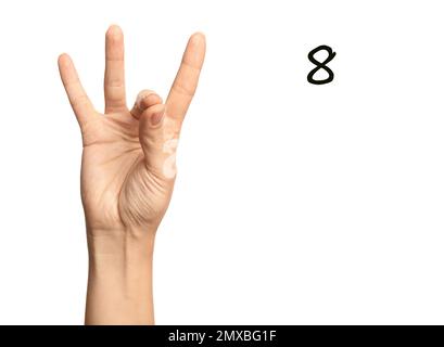 Woman showing number eight on white background, closeup. Sign language Stock Photo
