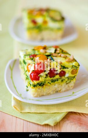 slices of vegetable gratin(quiche) with zucchini,tomato cherry and rice