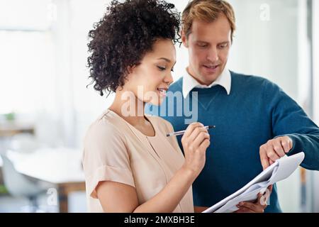 That design is really good. two colleagues discussing ideas on a notepad. Stock Photo