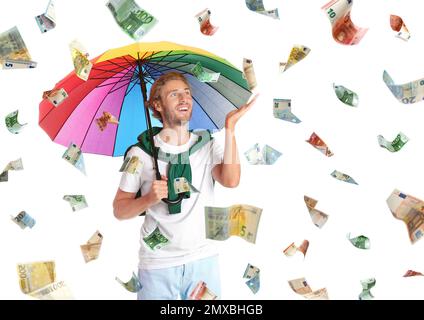 Man with umbrella under money rain on white background Stock Photo