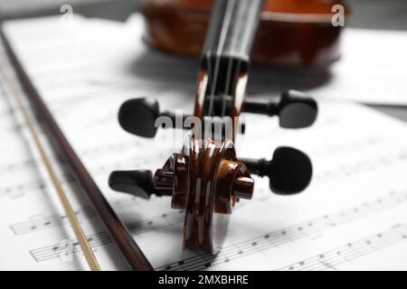 Classic violin, bow on note sheets, closeup Stock Photo