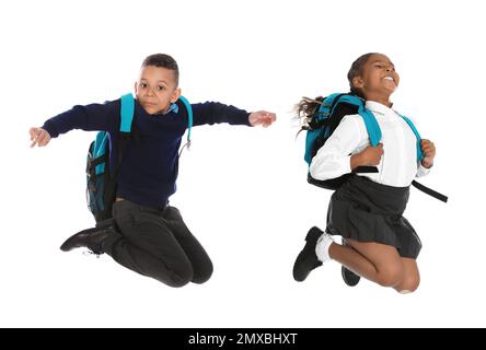 African American children in school uniform jumping on white background Stock Photo