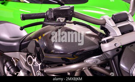 Warsaw, Poland. 8 February 2022. Green Porsche 911 GT3 RS sports car and black Ducati XDiavel S motorcycle parked in the underground garage. Stock Photo