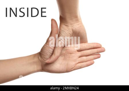 Woman showing word Inside on white background, closeup. American sign language Stock Photo