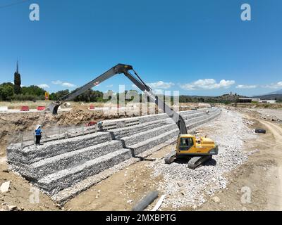 Long reach excavator working on a construction site. Stock Photo