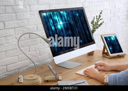Professional programmer working with computer in office, closeup Stock Photo