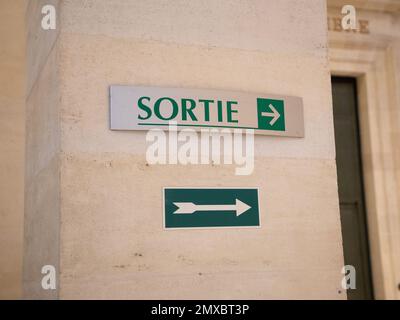 exit sign with arrow indicating in french text sortie means exit Stock Photo