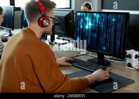 Professional programmer working with computer in office Stock Photo