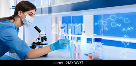 Scientist working with microscope and test tubes for analysis in laboratory. Banner design Stock Photo