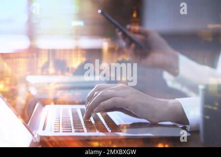 Double exposure of female programmer using laptop and cityscape, closeup Stock Photo