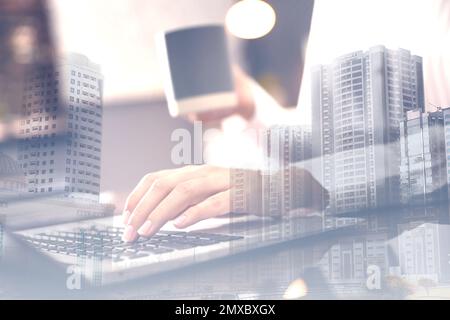 Double exposure of female programmer using laptop and cityscape, closeup Stock Photo