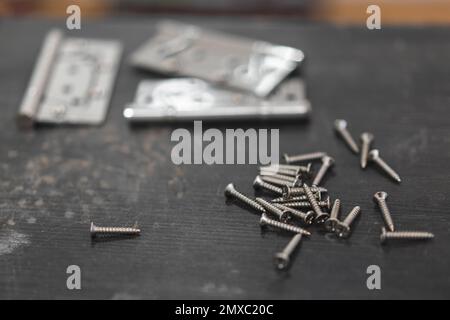 many different screws master on the craftsman's table for work Stock Photo
